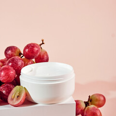 Organic cosmetics with grape seed oil. Zero Waste Winemaking. Skincare face cream and grapes on...
