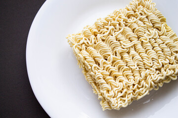 Noodles on a plate. Vermicelli in the shape of a square on a round plate.