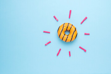Orange doughnut and rays from tubes on a blue background.