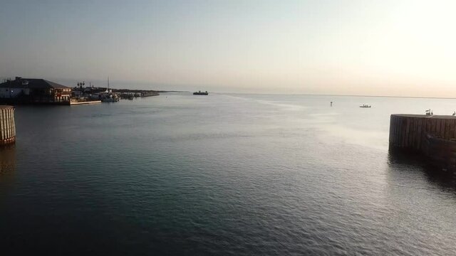Aerial drone view 0f shipping channel of the Gulf Intercoastal Waterway in northern Laguna Madre; flying under the JKF Causeway bridge along the shore line; North Padre Island, Corpus Christi Texas