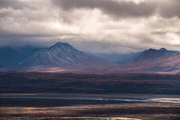 dramatic autumn landscape photo of he mountain peaks and valleys inside the Denali National Park in Alaska