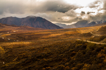 dramatic autumn landscape photo of he mountain peaks and valleys inside the Denali National Park in Alaska