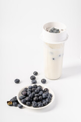 Healthy nutritious breakfast blueberry milkshake on white background