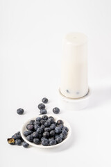 Healthy nutritious breakfast blueberry milkshake on white background