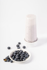 Healthy nutritious breakfast blueberry milkshake on white background
