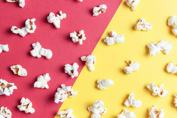 Popcorn pattern on red and yellow background close-up, top view