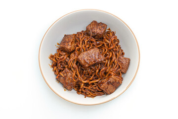 Jjapaguri or Chapaguri, Korean Black Beans Spicy Noodles with Beef on white background