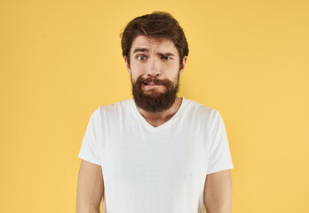 Obraz premium portrait of a man white t-shirt yellow background cropped view Copy Space