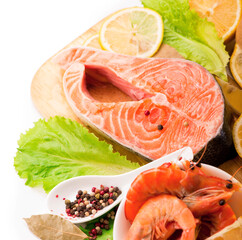 Fresh salmon steak filet, ginger, lemon, soy sause and chopsticks