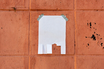 Tear off paper on paint wall. Mock up template. Street paper ad or announcement with tear-off stripes with phone number. Blank design. Copyspace mockup
