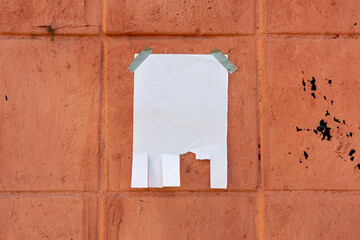 Tear off paper on paint wall. Mock up template. Street paper ad or announcement with tear-off...