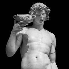 Ancient statue of Dionysus isolated on a black background. Dionysus is the God of the grape harvest, wine and merriment. Also known as Bacchus