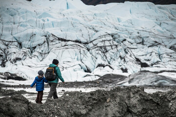 mother and son hiking near glacier in Matanuska , Alaska