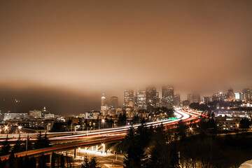 Fototapeta na wymiar light trails from traffic in a foggy night in Seattle area