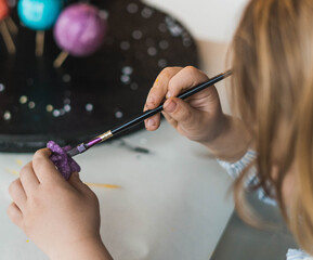 child painting planets