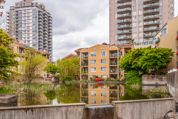 Modern Apartment Buildings with flowers and water landscape in Vancouver, British Columbia, Canada.