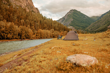 hiking tent on the beach of river.  © avtk