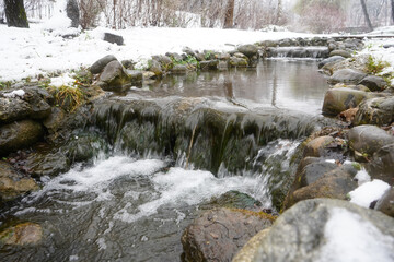 Waterfall of a river in winter. Photo during the day.