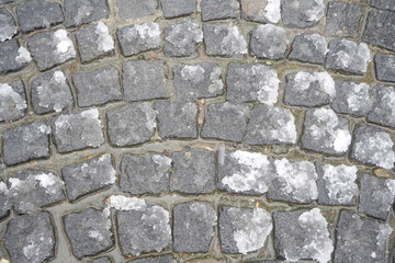 Fototapeta premium Road built of cubic stone, covered with snow.