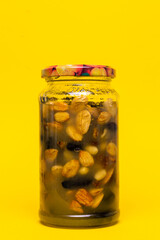 jam from nuts in a jar on a yellow background