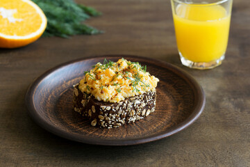 Eggs on rye bread with greens. Delicious breakfast.