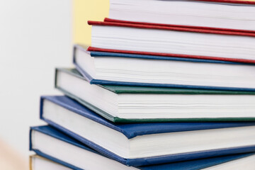 Stack of books on light background, closeup