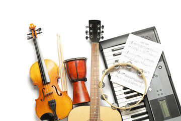 Different musical instruments and music notes on white background