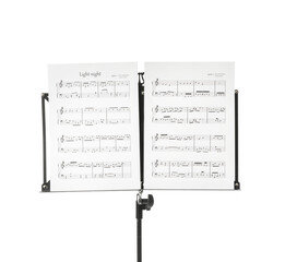 Note stand with music sheets on white background