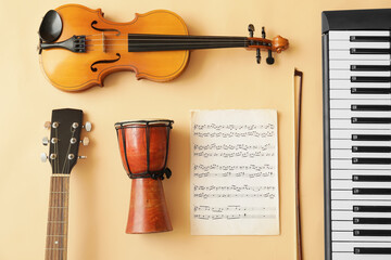 Different musical instruments and music notes on color background