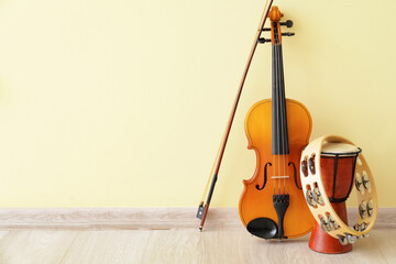Different musical instruments near color wall