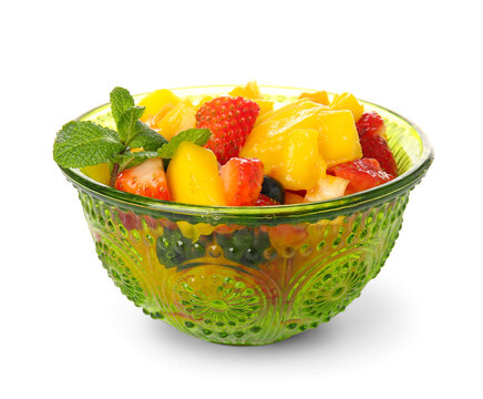 Bowl with tropical fruit salad on white background