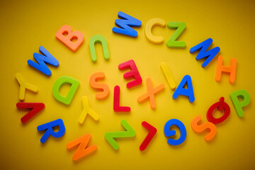 Multicolored plastic letters make word dyslexia on yellow background. Dyslexia or reading disorder...