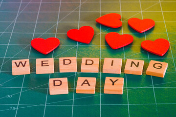 Wedding day text with red heart sign on background.