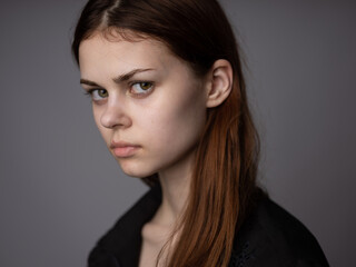 Portrait of a red-haired woman on a gray background beautiful face model cropped view