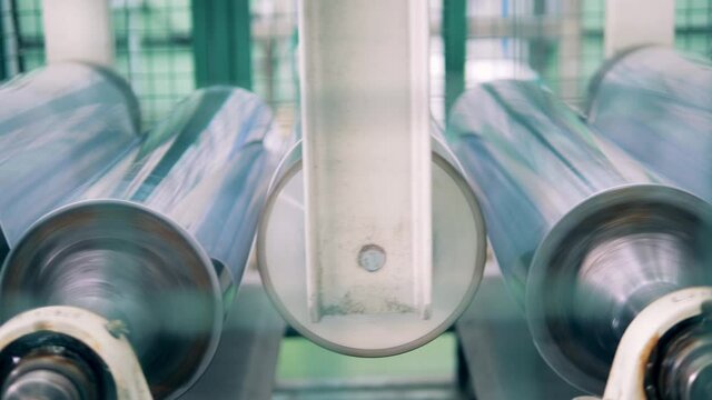 Plastic production, polymer recycling factory. Close up shot of a modern PVC sheet making machine