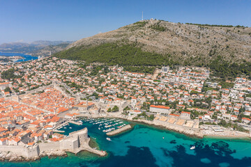 Aerial drone shot of Dubrovnik old town Banje beach in Adriatic sea in Croatia summer