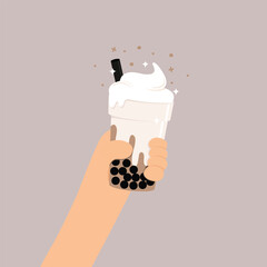 Hand holding milk tea with bubble and whipped cream. 