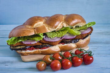 Chicken Schnitzel Challah Sandwich with tomato sauce, grilled eggplant, red onion, fresh lettuce on...