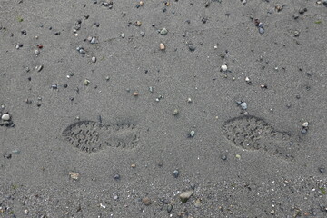 Close-up the sharp precise clear footprint in the grey sand beach