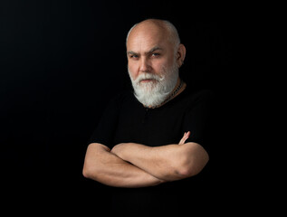 Bearded middle-aged man with a serious expression in a closeup head and shoulders portrait.