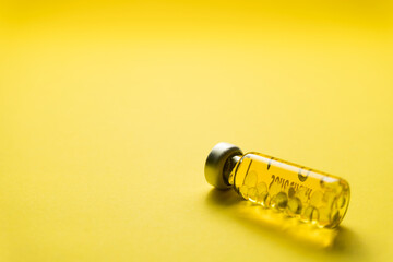 Fototapeta premium Sample Vaccine bottle with yellow background, Medical and health concept for banner and advertising.