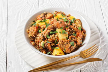 braised Rabbit with potatoes in a white bowl