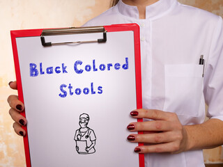 Healthcare concept about Black Colored Stools with phrase on the page.