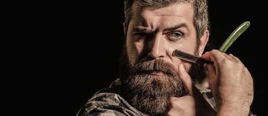 Straight razor, barbershop, beard. Portrait of brutal bearded man. Vintage straight razor. Mens haircut. Man in barbershop