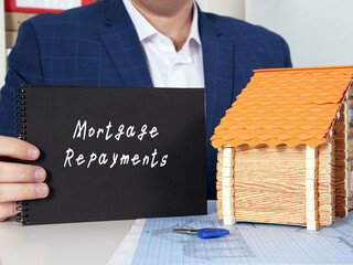Business concept meaning Mortgage Repayments with inscription on black notepad.