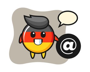 Cartoon illustration of germany flag badge standing beside the At symbol