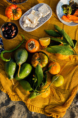 Fragment of an autumn picnic with tomatoes, avocadors, cheese, o