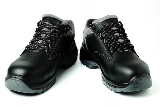 Brand new black leather safety shoes. Special construction workers boots isolated on white. Workboots for safety work at construction site