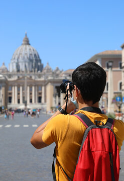 tourist photographs St. Peter's Basilica in Rome