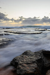 Wave flowing between rock formation.